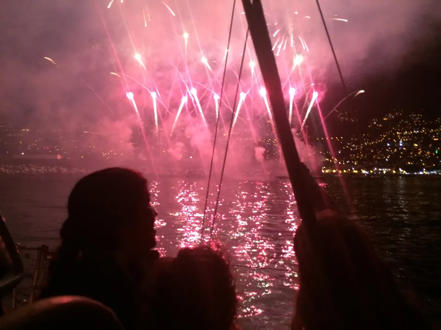 Guests on deck watching fireworks over Funchal at night